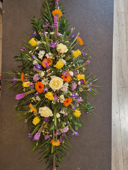 Lilac, orange, yellow and white coffin/casket spray